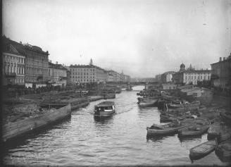 Barges on the Fontanka River near Semenovsky Bridge. Photo by Y. V. Steinberg. 1900s.